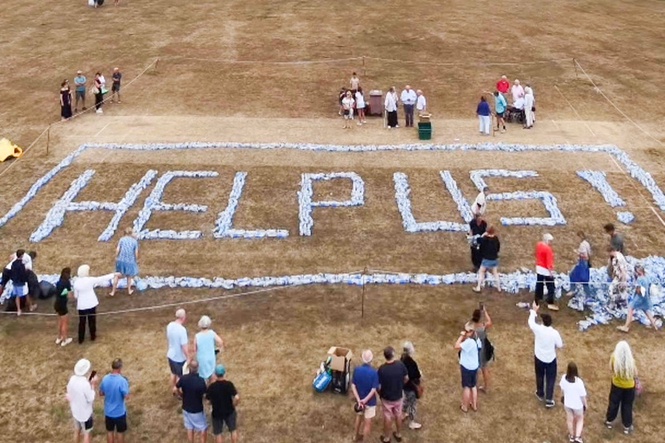 Angry villagers spell out ‘help us’ with plastic bottles after going days without water