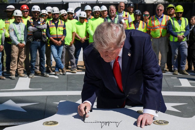 Trump brings trusty Sharpie on impromptu White House tour to sign helipad granite eagle