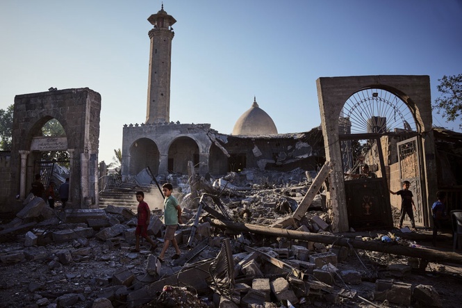 A damaged building collapses in Gaza, killing at least 12 people and other Mideast developments