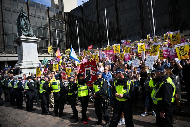 Burkha-wearing man charged with hiding identity at anti-migrant protest