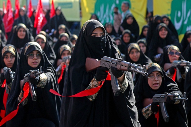 Iranians stage massive rally as Tehran urges citizens to take up arms