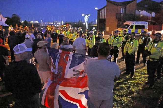 12 arrested after anti-migrant protesters clash with police over migrant dinghy arrival in UK seaside town