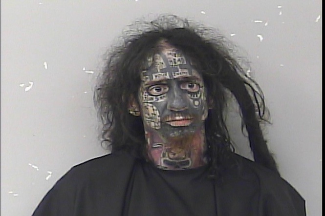 Bizarre mugshot shows ‘demonologist’ accused of tracking women by their phones
