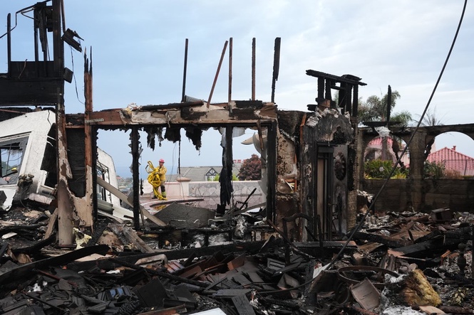 Photos show wildfire fueled by high winds engulfing coastal homes in Southern California