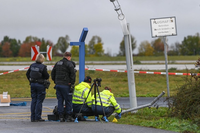 German police say 2 men turned themselves in after smashing their car into an airport fence