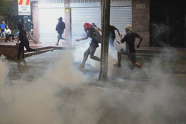 Image from: Protesters burn US flags, clash with riot police after Colombia vote