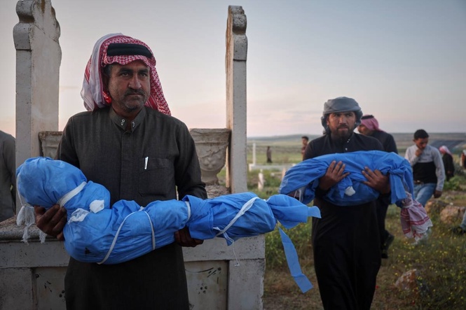 A grieving father buries his 6-year-old after a land mine kills 3 children in Syria's Idlib