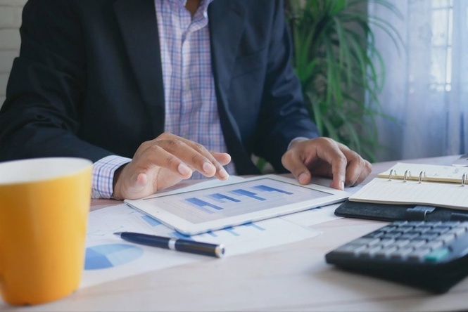 Business professional reviewing web app project data before hiring a developer